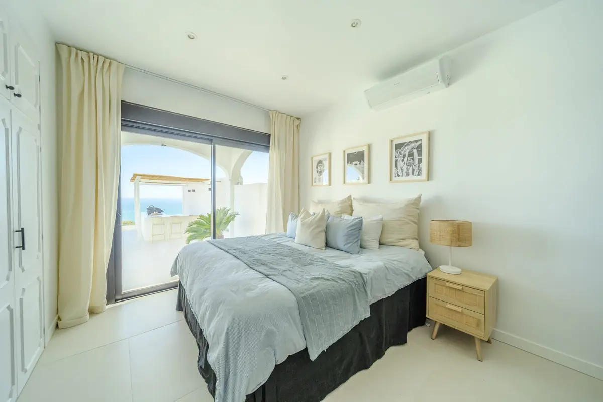 Bedroom at Villa Zentosa with an oak bedside table and garden doors